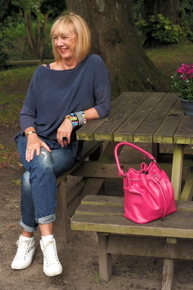 bangles, boyfriend jeans and a pink bag