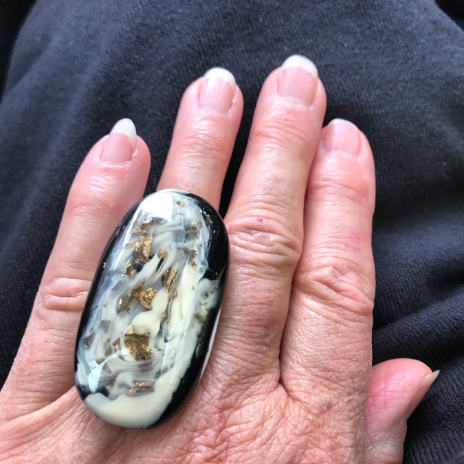 Black white and gold plastic ring