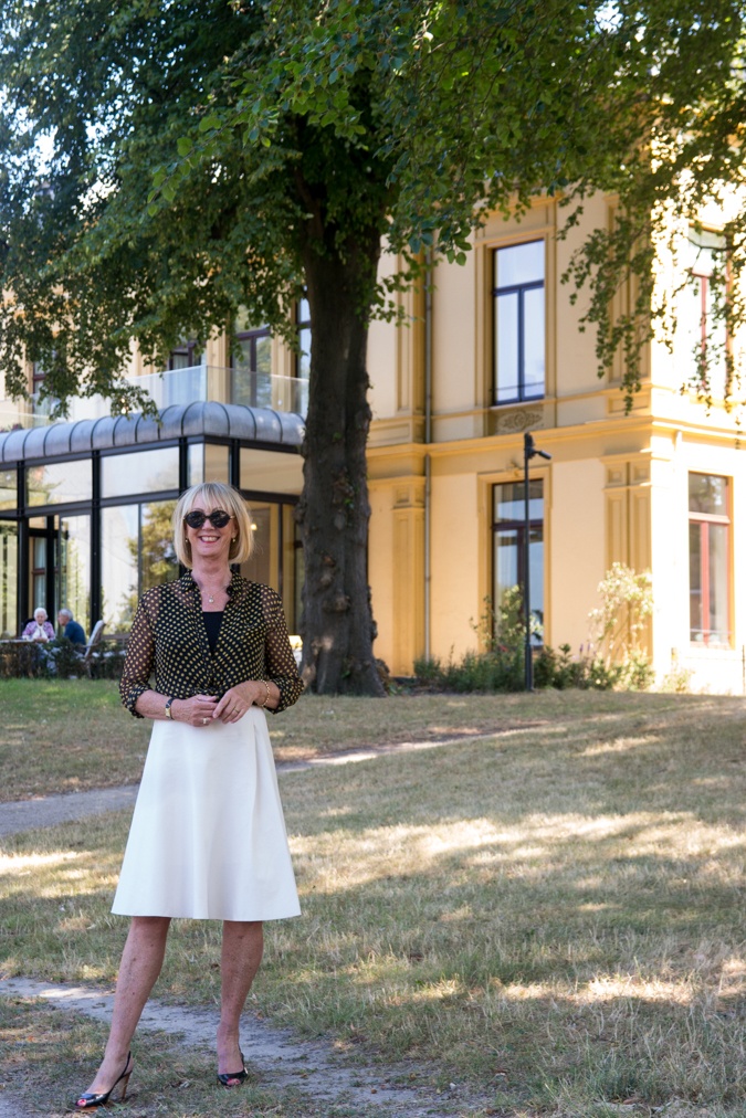 Wide cream skirt with black and yellow polka dot blouse