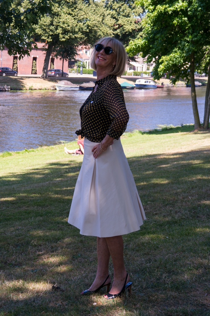 Wide cream skirt with black and yellow polka dot blouse