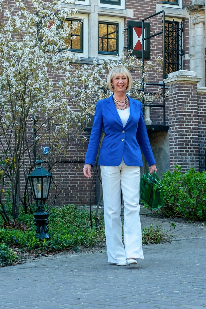 White flared trousers with a bright blue jacket