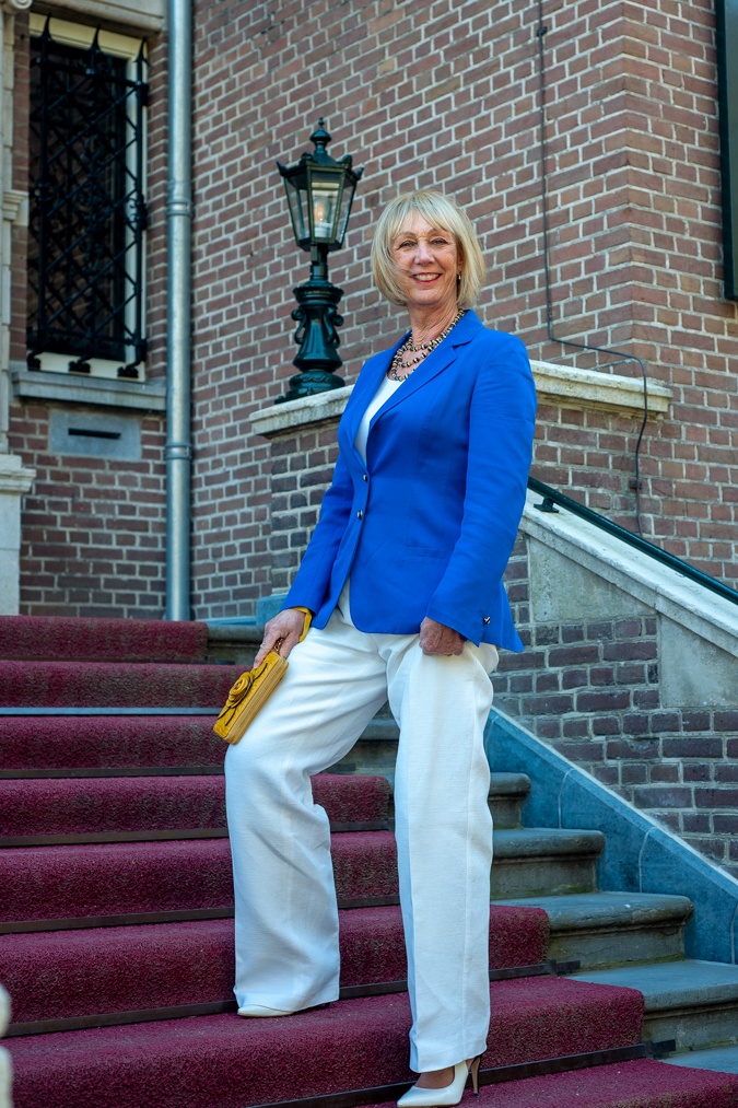 White flared trousers with a bright blue jacket
