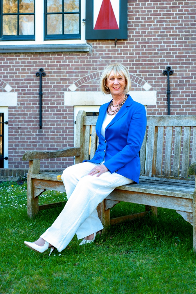 White flared trousers with a bright blue jacket