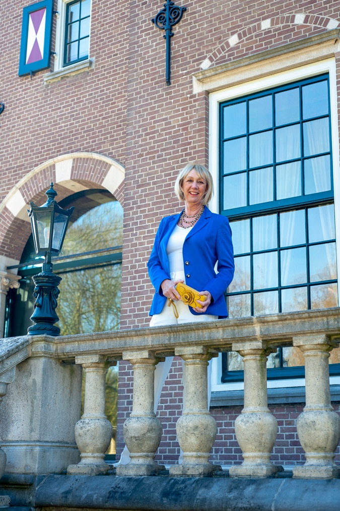 White flared trousers with a bright blue jacket