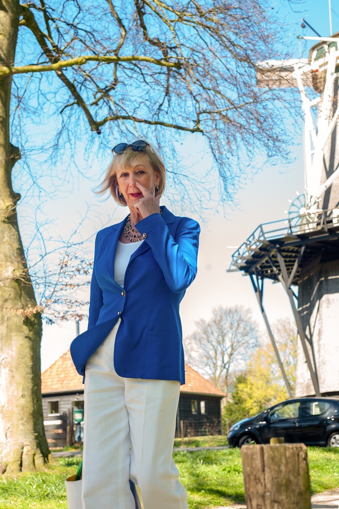 White flared trousers with a bright blue jacket