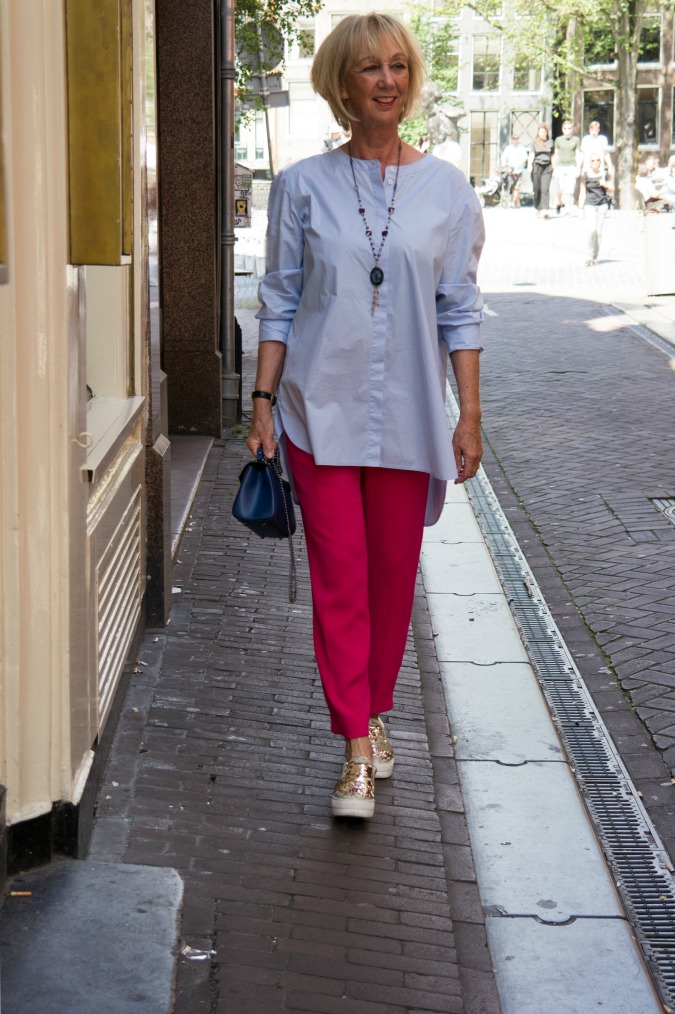 Bright pink trousers with baby blue shirt