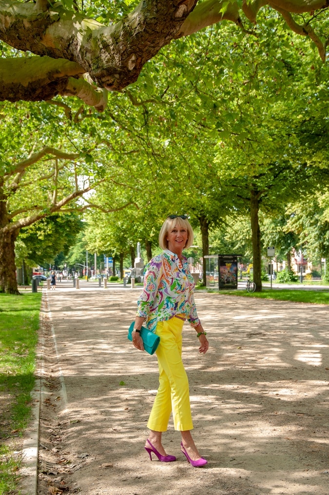 Lemon yellow trousers and a multi-coloured shirt
