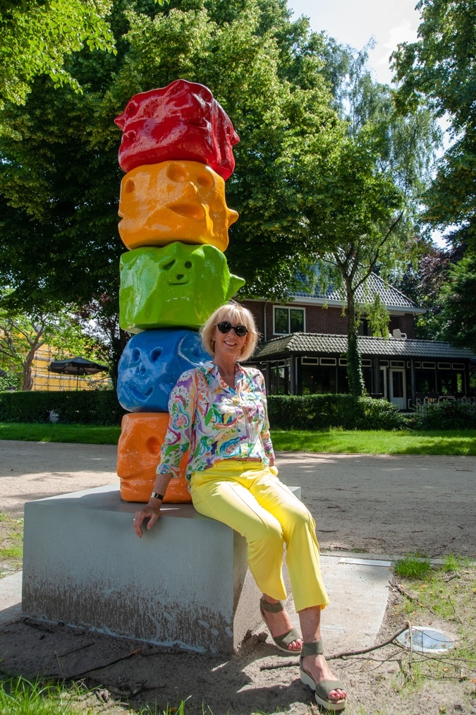 Lemon yellow trousers and a multi-coloured shirt