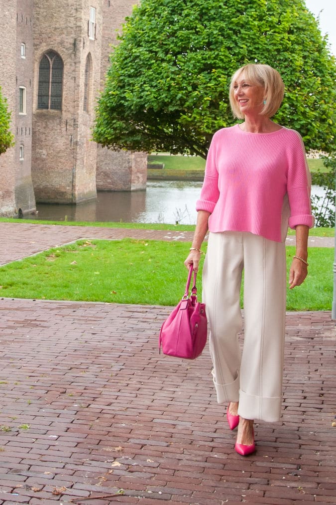 cream trousers and pink jumper
