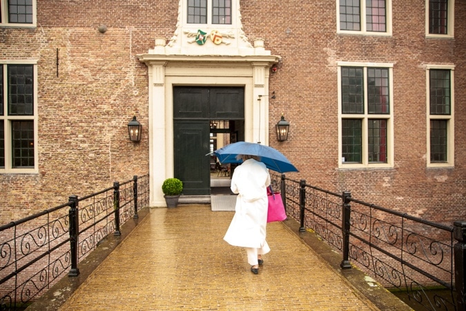 off-white trench coat in the rain