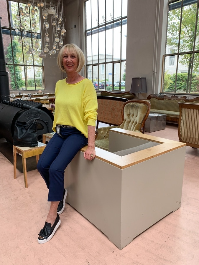 yellow sweater with blue trousers