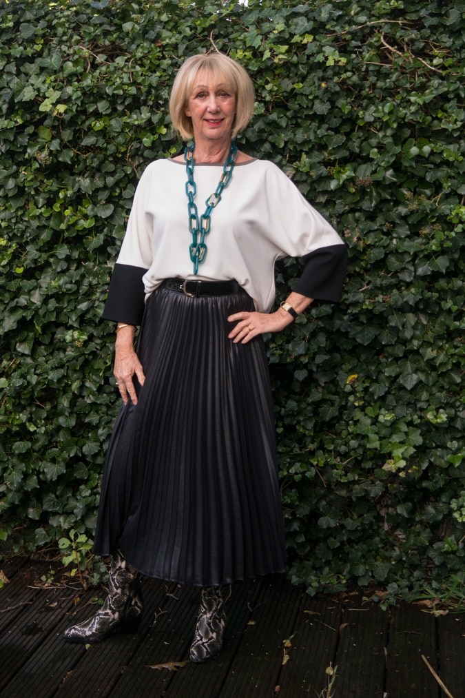 Python boots and black pleated skirt