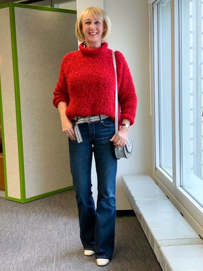 Big red jumper on flared jeans