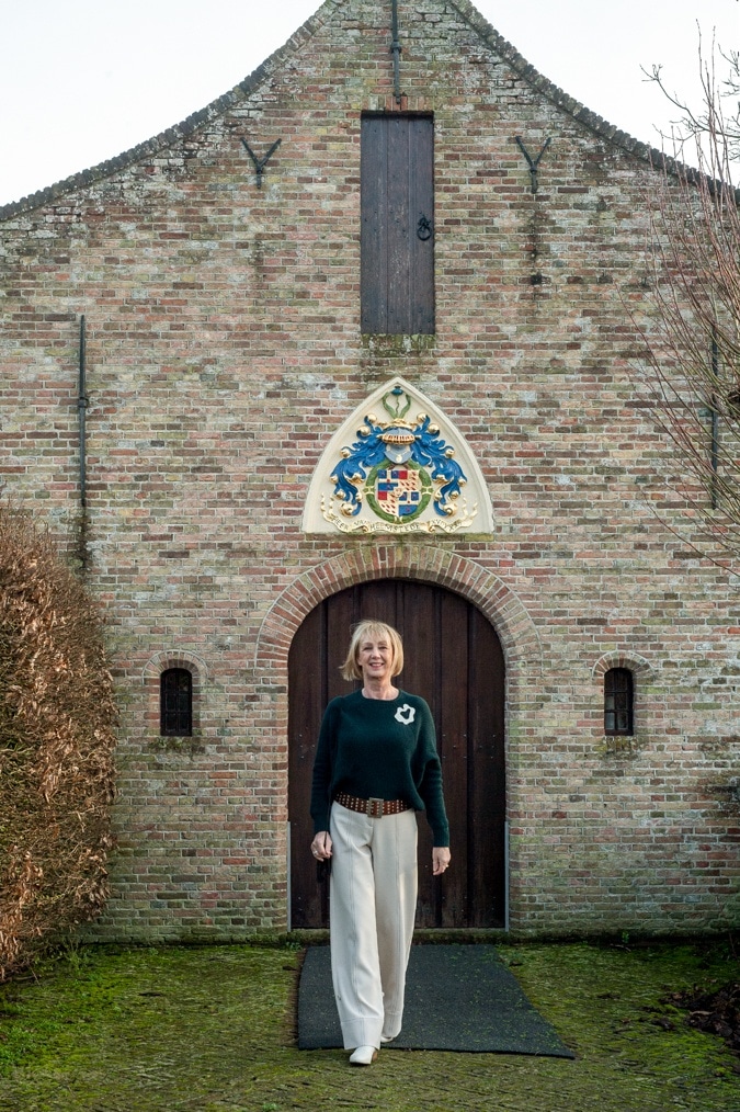Dark green jumper with cream trousers