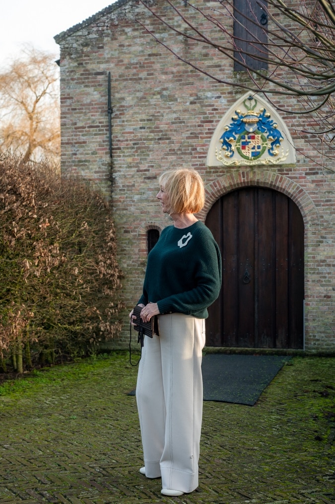 Dark green jumper with cream trousers