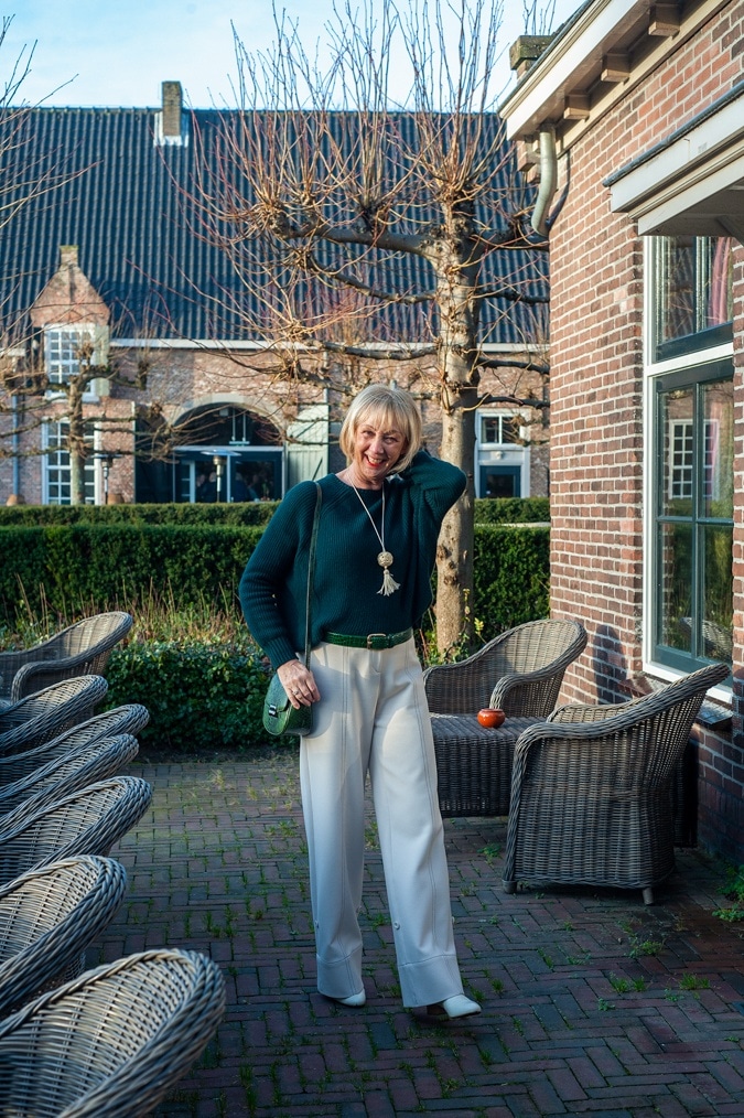 Dark green jumper with cream trousers
