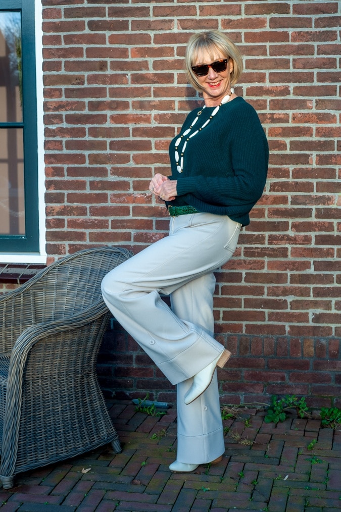 Dark green jumper with cream trousers
