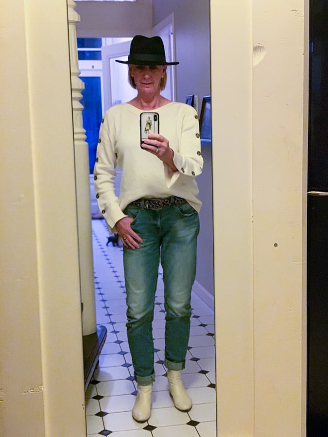 Blue hat with hair behind my ears
