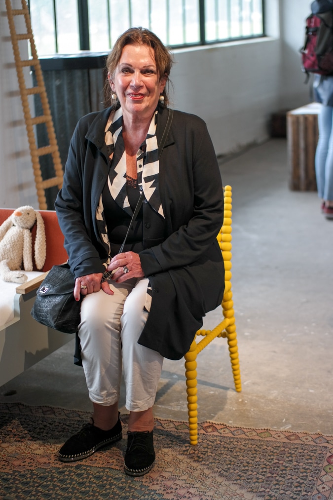 Monique sitting on the yellow chair at the OBJECT exhibition
