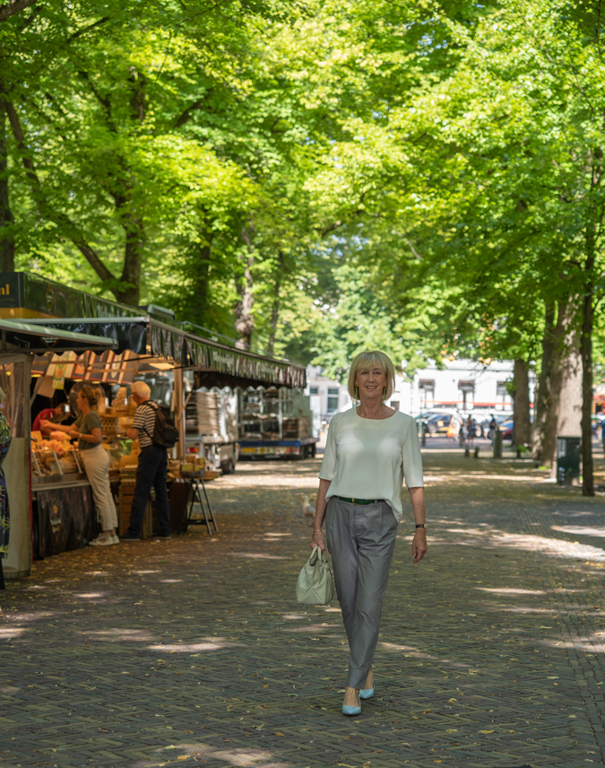 Grey trousers with a cream top in The Hague