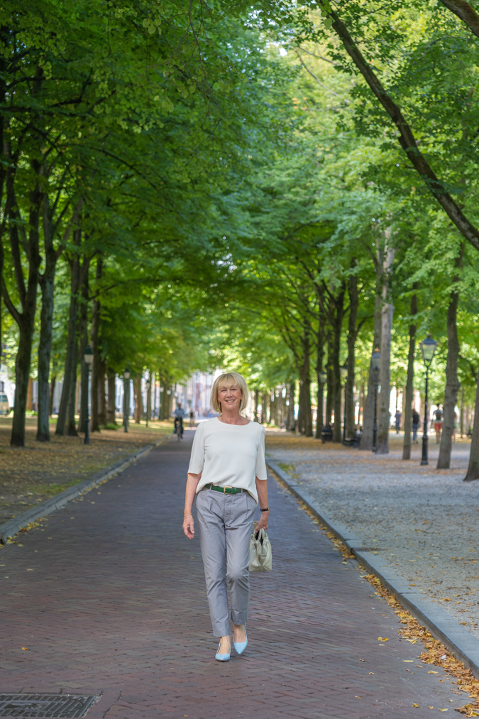 Grey trousers with a cream top in The Hague