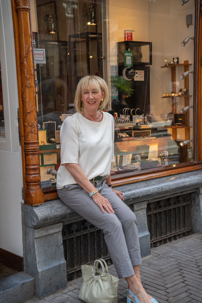 Grey trousers with a cream top in The Hague