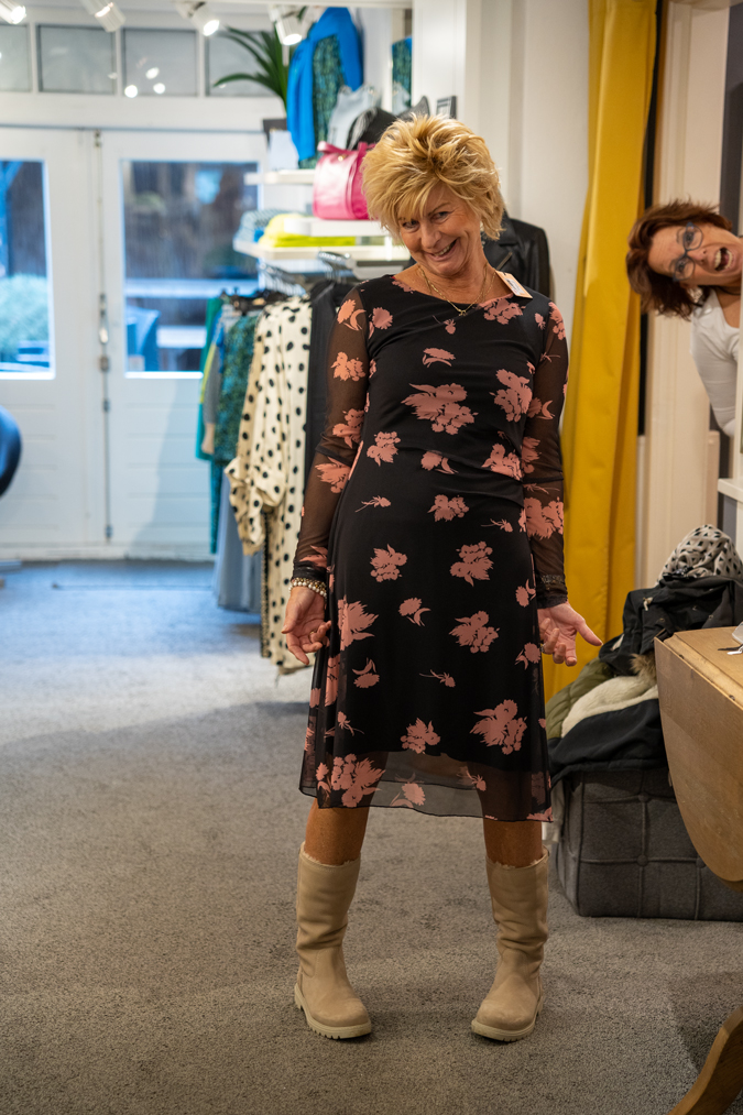 Marijke trying on a dress and Claudia photo bombing