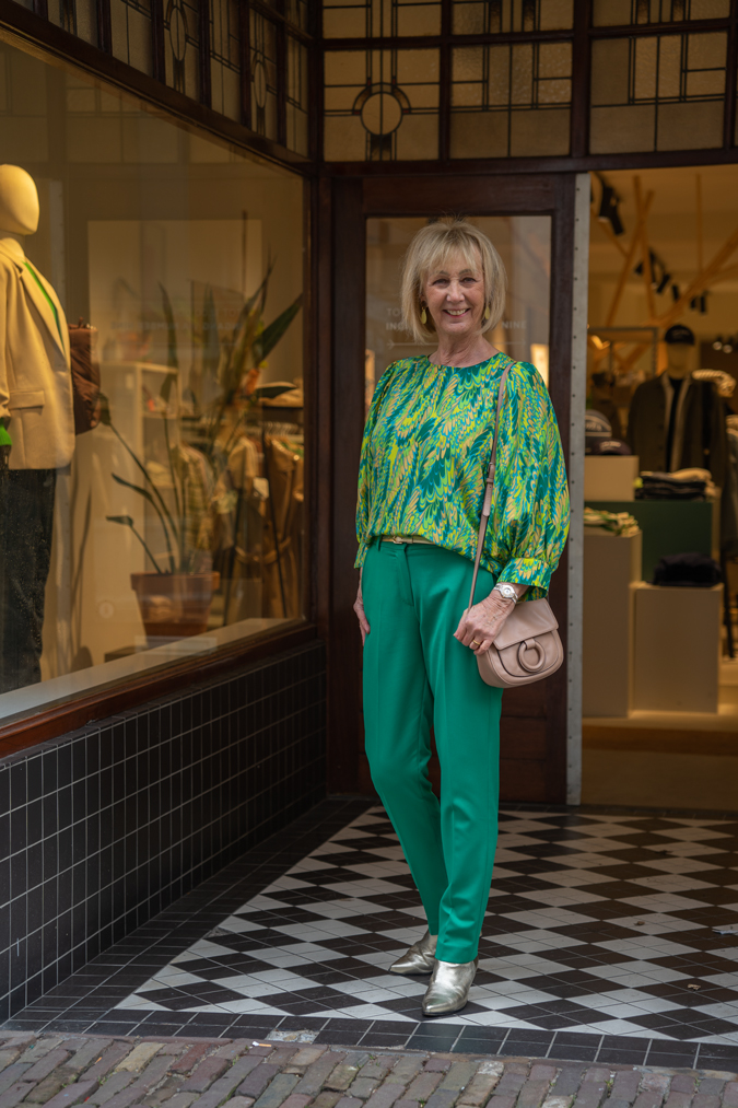 Green suit with green and yellow blouse