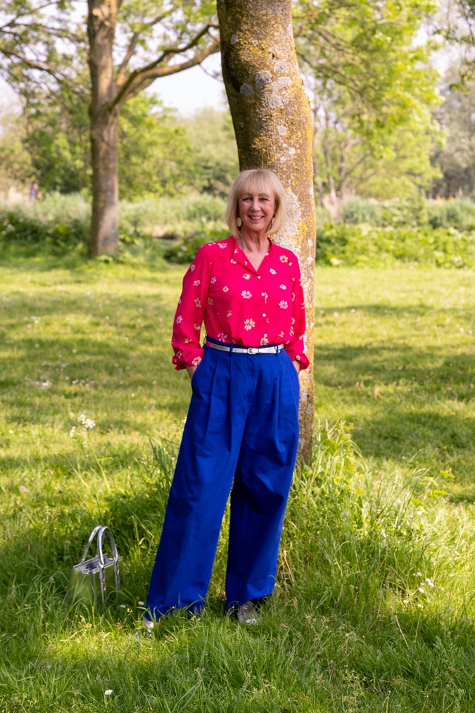 Bright blue trousers with bright pink blouse